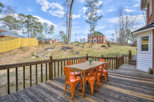 wooden terrace featuring outdoor dining space and fence