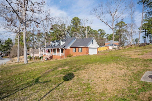 view of front of house featuring a garage, a porch, a front lawn, and brick siding