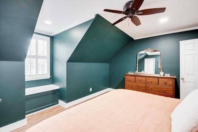 bedroom with ornamental molding, vaulted ceiling, ceiling fan, wood finished floors, and baseboards