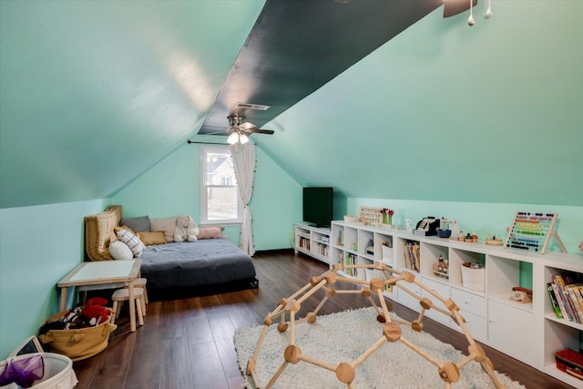 recreation room with lofted ceiling, hardwood / wood-style flooring, ceiling fan, and visible vents