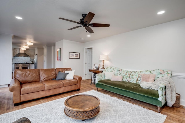 living area with a ceiling fan, wood finished floors, and recessed lighting