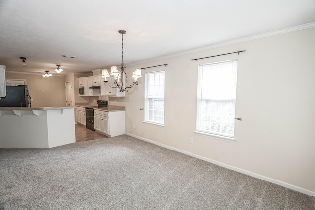 944 Cannock St, Grovetown, GA 30813 - kitchen with black electric range, refrigerator, a kitchen breakfast bar, a chandelier, and ornamental molding