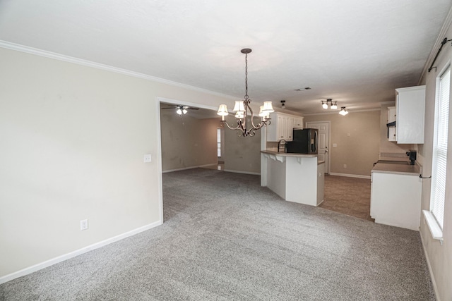 944 Cannock St, Grovetown, GA 30813 - kitchen with fridge, a chandelier, light colored carpet, a kitchen bar, and crown molding