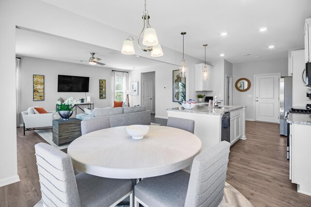 dining room featuring a ceiling fan, baseboards, wood finished floors, and recessed lighting