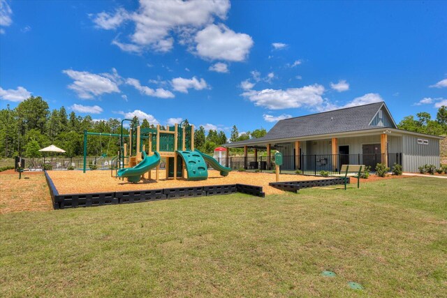 communal playground featuring fence and a yard