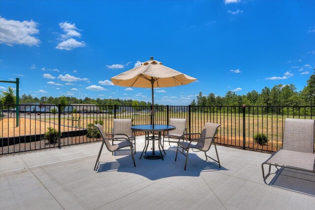 view of patio with outdoor dining space and fence