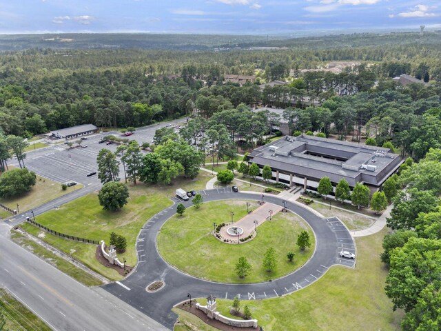 drone / aerial view featuring a wooded view