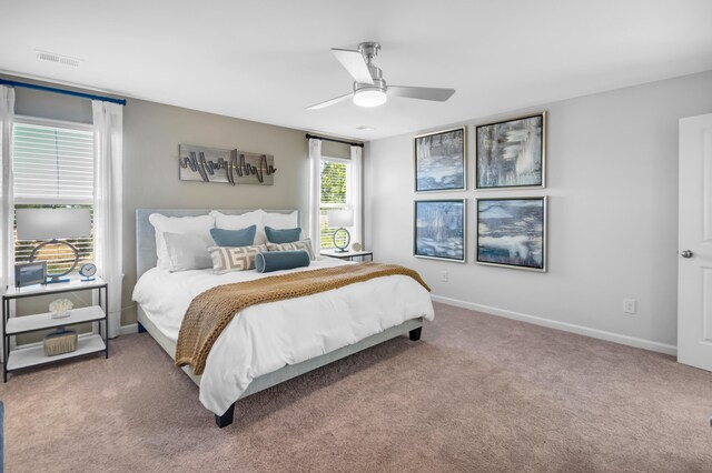 bedroom with ceiling fan, carpet floors, visible vents, and baseboards