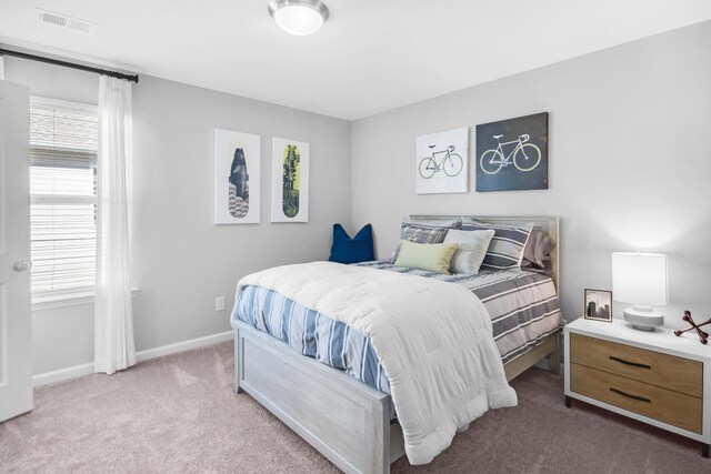 bedroom featuring carpet floors, visible vents, and baseboards