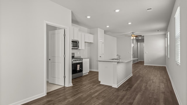 kitchen featuring a sink, backsplash, white cabinetry, and stainless steel appliances