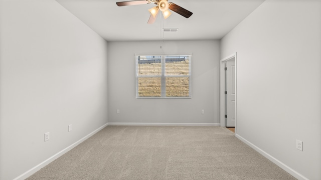 empty room with visible vents, baseboards, and carpet floors