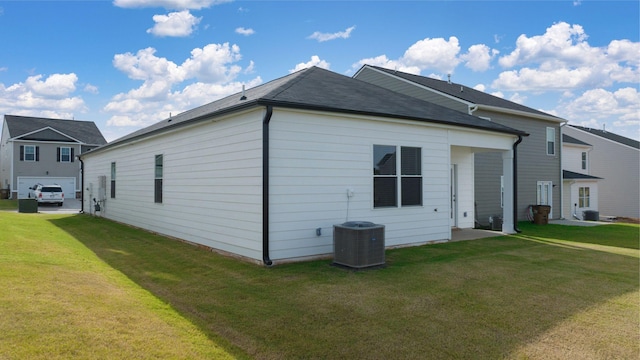 view of home's exterior with central air condition unit and a lawn