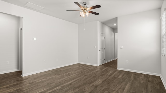 empty room with recessed lighting, dark wood-style floors, visible vents, and baseboards