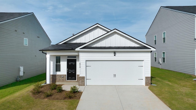 view of front of house with brick siding, board and batten siding, a front lawn, concrete driveway, and a garage