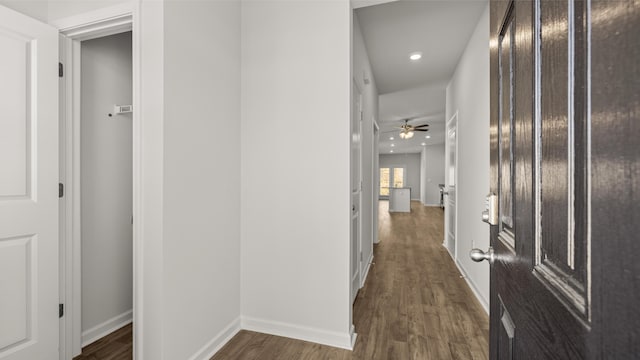 laundry room featuring dark wood-type flooring, baseboards, hookup for an electric dryer, hookup for a washing machine, and laundry area