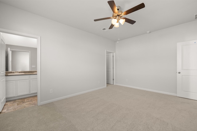 unfurnished bedroom featuring visible vents, baseboards, and light colored carpet