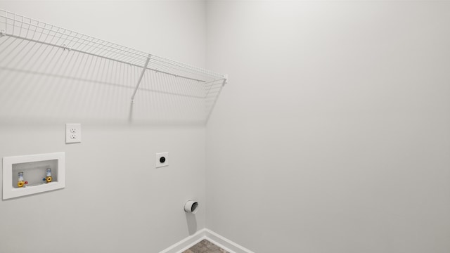 laundry area featuring laundry area, hookup for a washing machine, baseboards, and electric dryer hookup