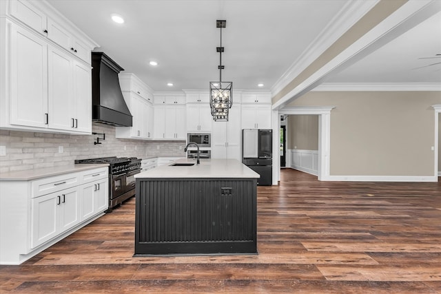 2120 Shell Point Ct, Harlem, GA 30814 - kitchen with appliances with stainless steel finishes, wall chimney exhaust hood, ornamental molding, dark wood-style floors, and white cabinets