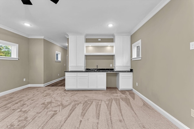 2120 Shell Point Ct, Harlem, GA 30814 - kitchen featuring crown molding, baseboards, light carpet, white cabinetry, and dark countertops