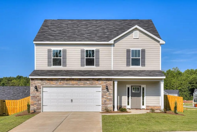 view of front of property with a garage and a front lawn