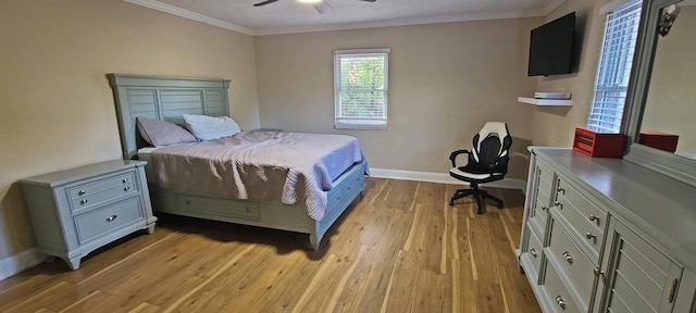 bedroom featuring ceiling fan, light wood-type flooring, and crown molding