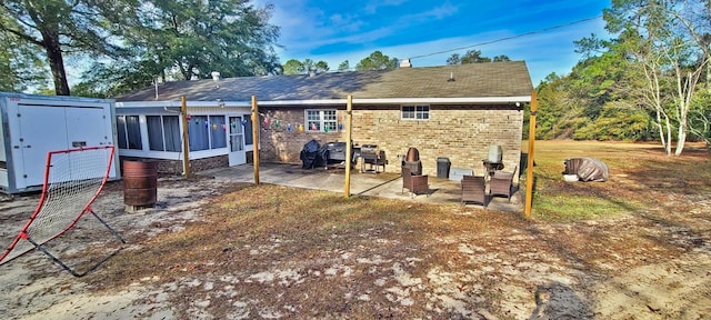 back of property featuring a sunroom and a patio