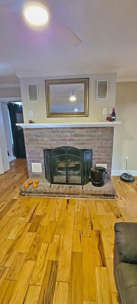 interior details with hardwood / wood-style floors and crown molding