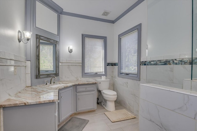 full bathroom featuring toilet, tile walls, vanity, visible vents, and crown molding