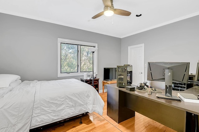 bedroom featuring ceiling fan, crown molding, and wood finished floors