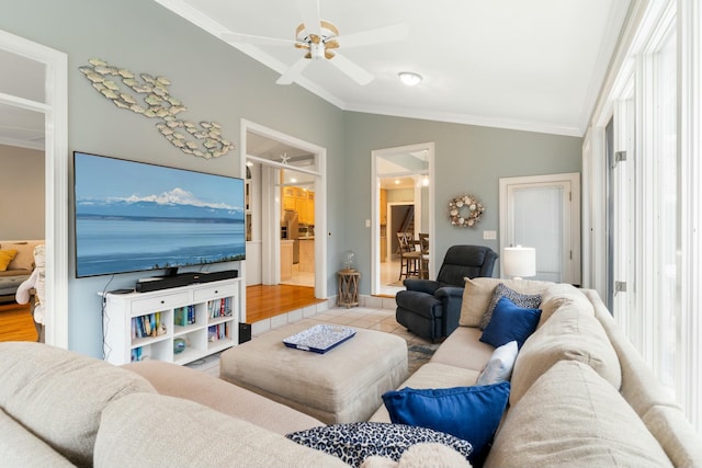 living room with ornamental molding, light tile patterned flooring, vaulted ceiling, and a ceiling fan