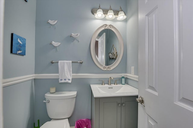 bathroom featuring toilet and vanity