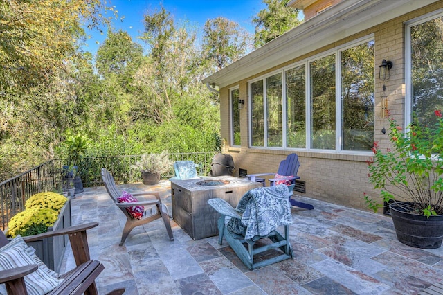 view of patio with fence and a fire pit