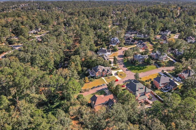 drone / aerial view with a residential view and a view of trees