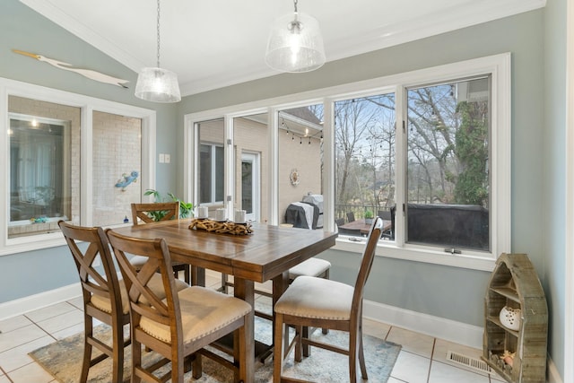 dining space with a healthy amount of sunlight, crown molding, baseboards, and light tile patterned floors