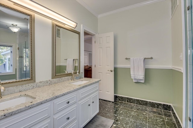 bathroom featuring double vanity, an enclosed shower, ornamental molding, and a sink