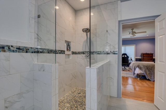 ensuite bathroom featuring wood finished floors, walk in shower, ensuite bath, and a ceiling fan