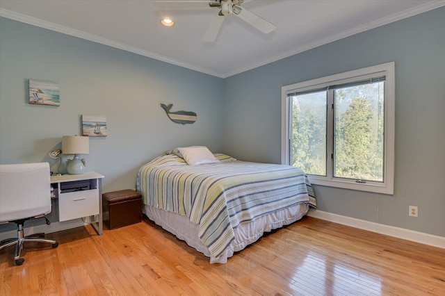 bedroom featuring ornamental molding, light wood-type flooring, ceiling fan, and baseboards