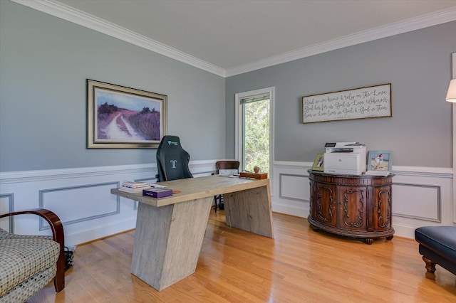 office area with ornamental molding, a wainscoted wall, and light wood finished floors