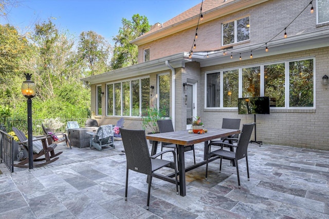 view of patio with a fire pit and outdoor dining area