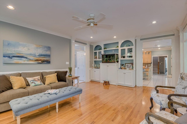 living room with light wood finished floors, ceiling fan, crown molding, and recessed lighting