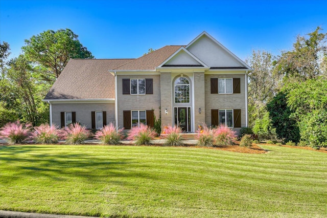 greek revival house featuring a front lawn