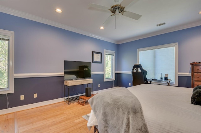 bedroom featuring multiple windows, visible vents, and crown molding