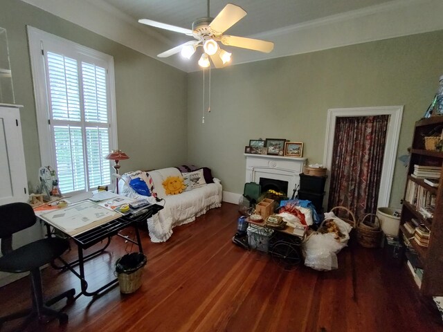 206 S Alexander Ave, Washington, GA 30673 - bedroom with a lit fireplace, a ceiling fan, and wood finished floors
