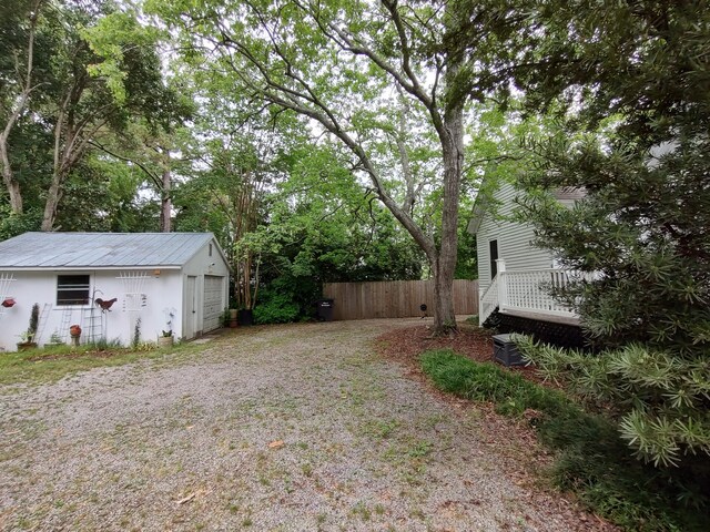 206 S Alexander Ave, Washington, GA 30673 - view of yard featuring fence, gravel driveway, and an outbuilding