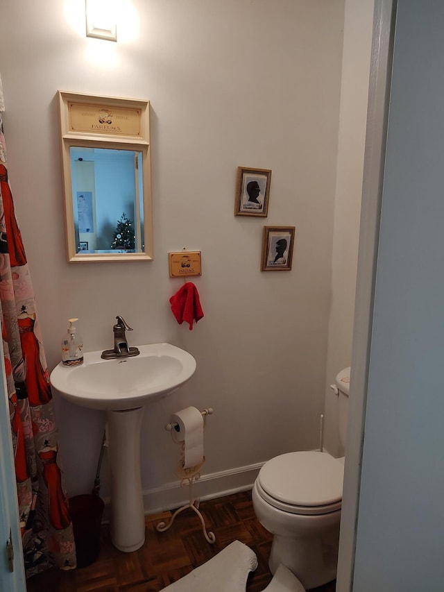 206 S Alexander Ave, Washington, GA 30673 - bathroom featuring toilet and baseboards