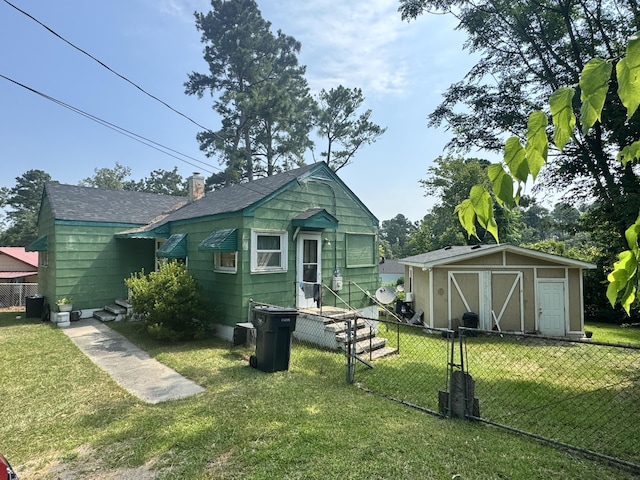 2916 Whistler Ln, Augusta, GA 30906 - rear view of property with a storage unit and a shingled roof