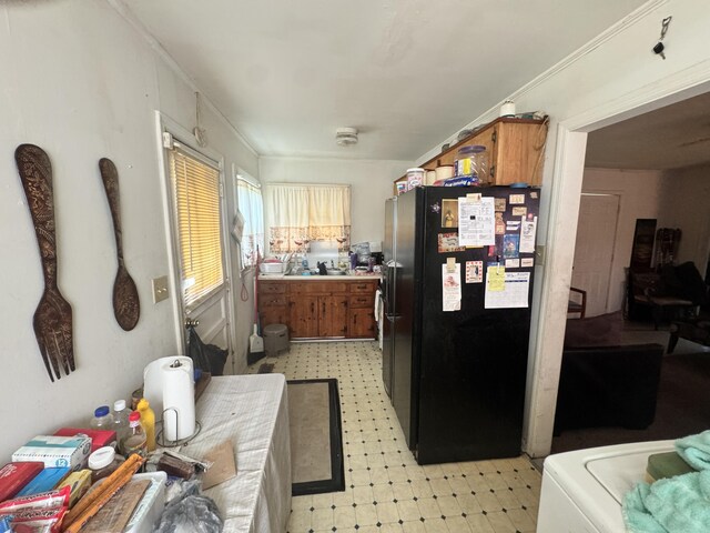 2916 Whistler Ln, Augusta, GA 30906 - kitchen with freestanding refrigerator, light flooring, and brown cabinetry