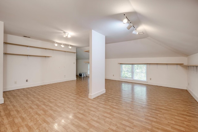 4142 Rivermont Dr, Evans, GA 30809 - unfurnished living room with rail lighting, light wood-style flooring, and lofted ceiling