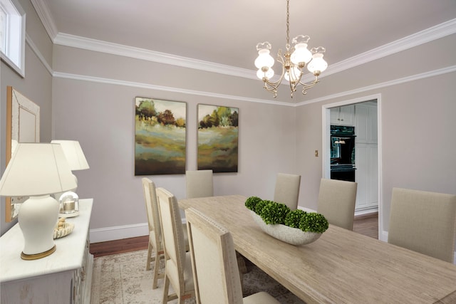 4142 Rivermont Dr, Evans, GA 30809 - dining area featuring wood finished floors, a chandelier, and crown molding