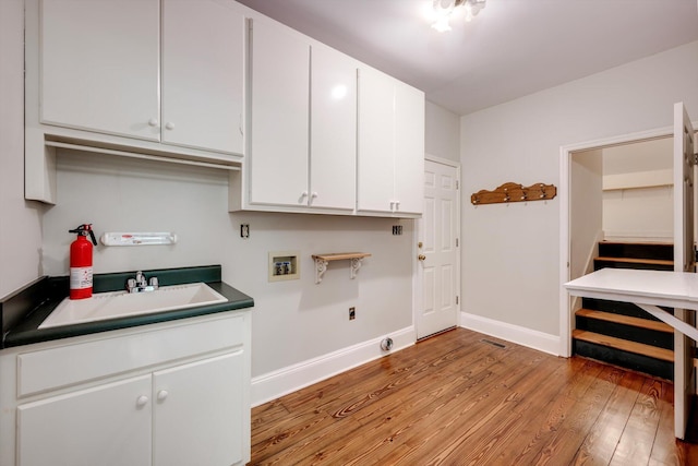 4142 Rivermont Dr, Evans, GA 30809 - laundry area featuring light wood-style flooring, washer hookup, cabinet space, and hookup for an electric dryer